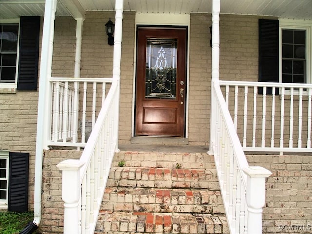 11001 Old Church Rd, New Kent, VA 23124 - property entrance featuring a porch and brick siding