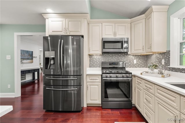 13908 Sunrise Bluff Rd, Midlothian, VA 23112 - kitchen featuring appliances with stainless steel finishes, dark wood-style floors, light countertops, and vaulted ceiling