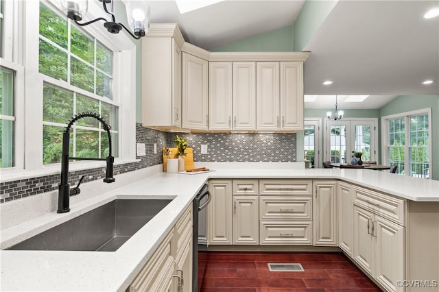 13908 Sunrise Bluff Rd, Midlothian, VA 23112 - kitchen featuring a chandelier, vaulted ceiling, a skylight, dishwasher, and light countertops