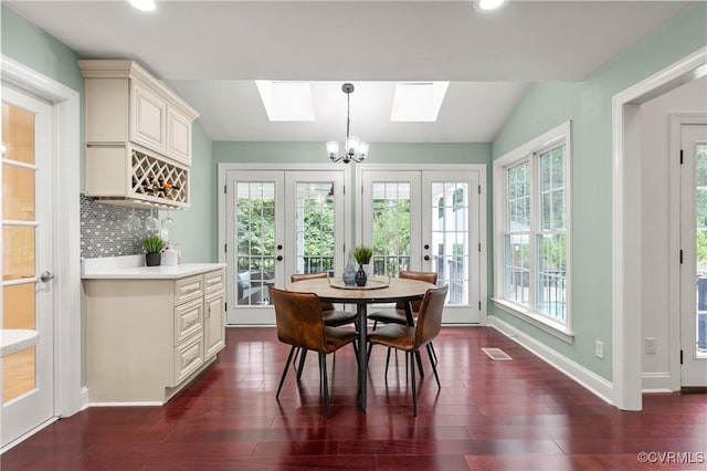 13908 Sunrise Bluff Rd, Midlothian, VA 23112 - dining space featuring a skylight, french doors, dark wood-style flooring, recessed lighting, and a chandelier