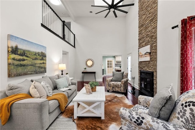 13908 Sunrise Bluff Rd, Midlothian, VA 23112 - living area featuring ceiling fan, a towering ceiling, a stone fireplace, and wood finished floors