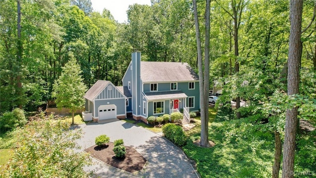 2805 Meeting Gate Ct, Chesterfield, VA 23112 - colonial inspired home featuring driveway, a garage, a chimney, a shingled roof, and board and batten siding
