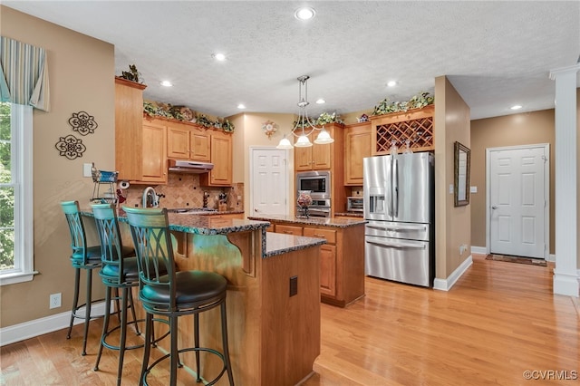 12300 Wynnstay Ln, Chesterfield, VA 23838 - kitchen with appliances with stainless steel finishes, under cabinet range hood, a peninsula, baseboards, and plenty of natural light