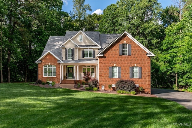 12300 Wynnstay Ln, Chesterfield, VA 23838 - view of front facade with brick siding, a front yard, a porch, and a shingled roof