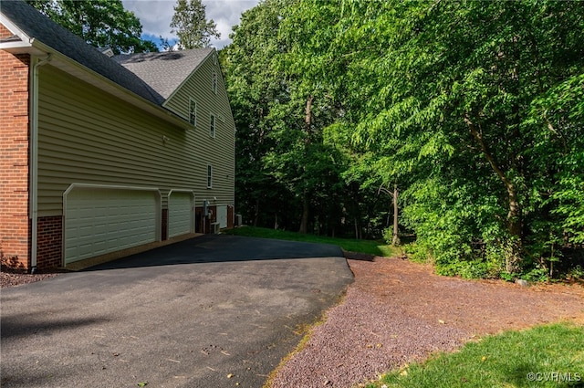12300 Wynnstay Ln, Chesterfield, VA 23838 - view of property exterior featuring driveway, brick siding, and roof with shingles