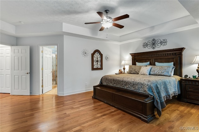 12300 Wynnstay Ln, Chesterfield, VA 23838 - bedroom featuring a raised ceiling, light wood-style floors, baseboards, a textured ceiling, and a ceiling fan