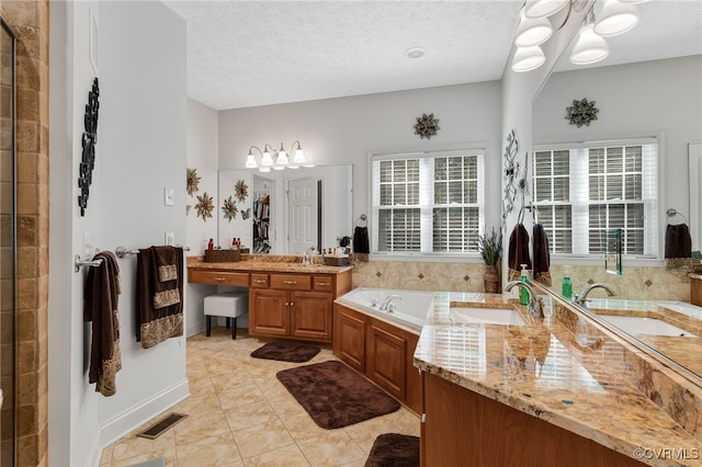 12300 Wynnstay Ln, Chesterfield, VA 23838 - bathroom with a garden tub, vanity, a chandelier, tile patterned floors, and a textured ceiling
