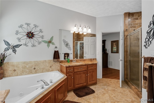 12300 Wynnstay Ln, Chesterfield, VA 23838 - bathroom featuring vanity, a whirlpool tub, a shower stall, tile patterned floors, and a textured ceiling
