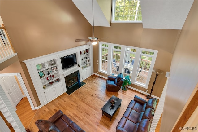 12300 Wynnstay Ln, Chesterfield, VA 23838 - living area featuring a high ceiling, a fireplace with flush hearth, light wood-style flooring, a ceiling fan, and baseboards