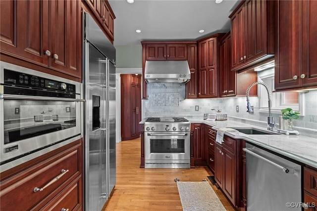 2011 Grove Ave, Richmond, VA 23220 - kitchen featuring premium appliances, a sink, exhaust hood, reddish brown cabinets, and recessed lighting