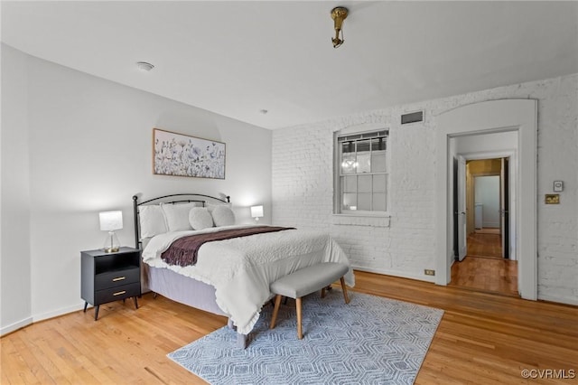 2011 Grove Ave, Richmond, VA 23220 - bedroom featuring wood finished floors and brick wall
