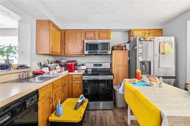 4822 Ballyshannon Ct, Henrico, VA 23228 - kitchen featuring stainless steel appliances, a sink, dark wood-style floors, light countertops, and brown cabinets