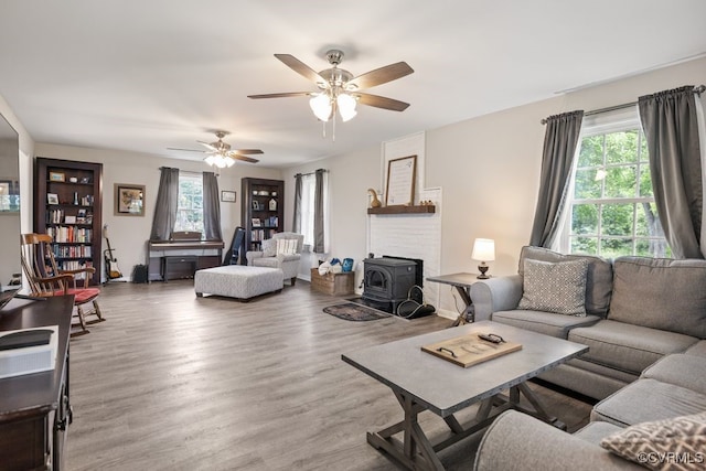 16619 Jefferson Hwy, Bumpass, VA 23024 - living room featuring wood finished floors, a wood stove, and a ceiling fan