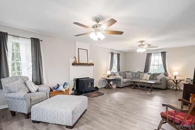 16619 Jefferson Hwy, Bumpass, VA 23024 - living area featuring a wood stove, wood finished floors, and ceiling fan