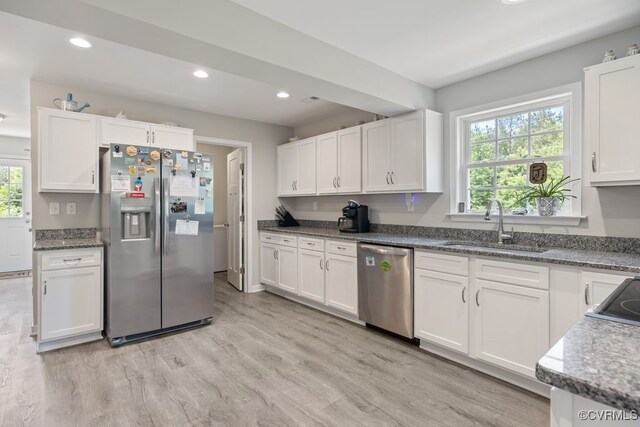 16619 Jefferson Hwy, Bumpass, VA 23024 - kitchen featuring appliances with stainless steel finishes, a sink, white cabinets, light wood-style floors, and recessed lighting