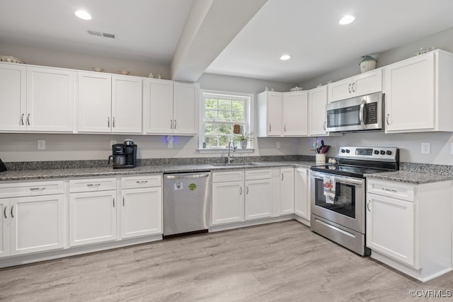 16619 Jefferson Hwy, Bumpass, VA 23024 - kitchen with appliances with stainless steel finishes, a sink, white cabinets, recessed lighting, and light wood-type flooring