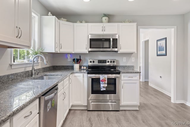 16619 Jefferson Hwy, Bumpass, VA 23024 - kitchen featuring appliances with stainless steel finishes, a sink, white cabinets, light wood finished floors, and recessed lighting