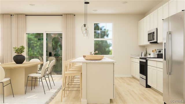 6641 Cassia Loop, Moseley, VA 23120 - kitchen with appliances with stainless steel finishes, light wood-style floors, a kitchen breakfast bar, and a kitchen island