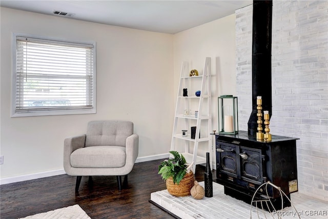 704 Athens Ave, Hampton, VA 23669 - sitting room with a wood stove, wood finished floors, and baseboards