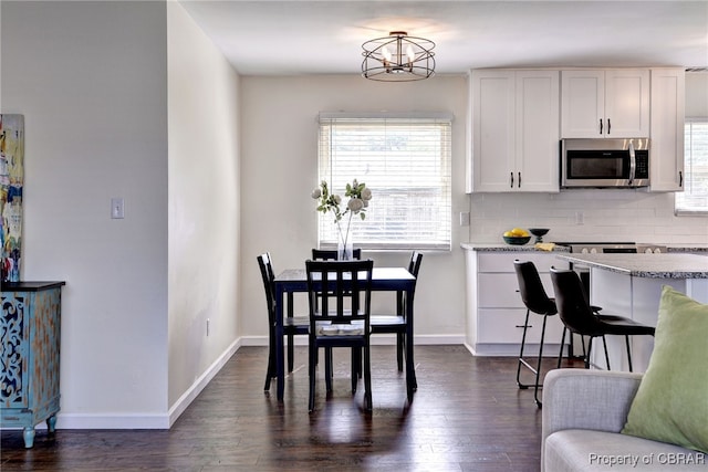 704 Athens Ave, Hampton, VA 23669 - dining room featuring dark wood-style floors, a chandelier, and baseboards