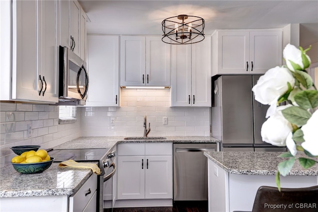 704 Athens Ave, Hampton, VA 23669 - kitchen featuring stainless steel appliances, a sink, tasteful backsplash, and light stone countertops