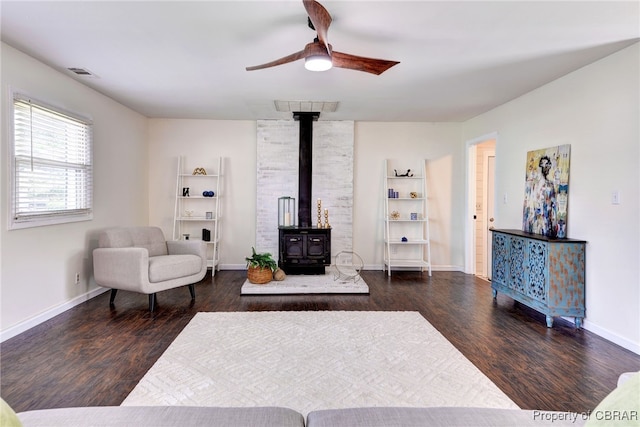 704 Athens Ave, Hampton, VA 23669 - living room with a wood stove, wood finished floors, a ceiling fan, and baseboards