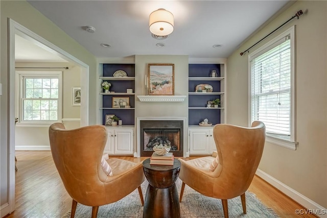 7400 Westfield Rd, Henrico, VA 23226 - sitting room featuring light wood-style flooring, a fireplace, baseboards, and built in features