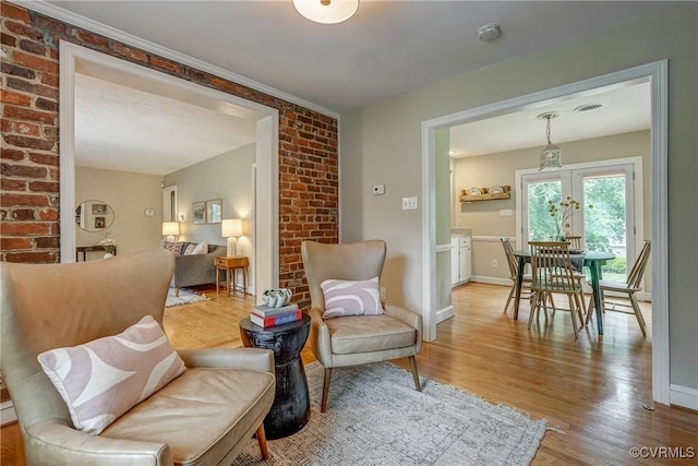 7400 Westfield Rd, Henrico, VA 23226 - living area with wood finished floors, french doors, brick wall, and baseboards