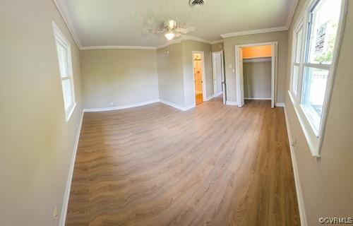 1217 Arlington St, Petersburg, VA 23803 - unfurnished bedroom featuring wood finished floors and crown molding