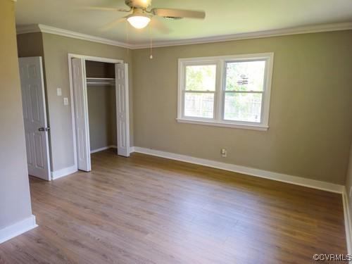 1217 Arlington St, Petersburg, VA 23803 - unfurnished bedroom with crown molding, wood finished floors, a closet, and ceiling fan