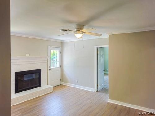 1217 Arlington St, Petersburg, VA 23803 - unfurnished living room with a ceiling fan, wood finished floors, crown molding, and a glass covered fireplace