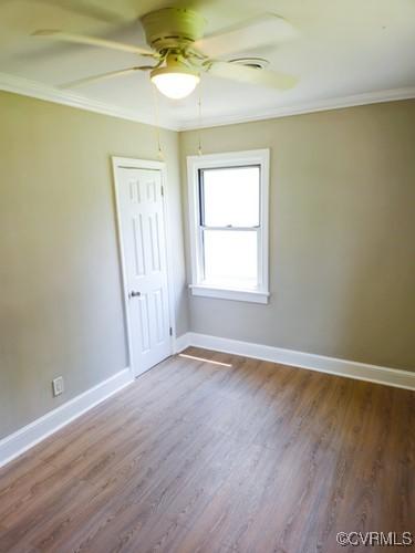 1217 Arlington St, Petersburg, VA 23803 - spare room featuring ornamental molding, a ceiling fan, and wood finished floors