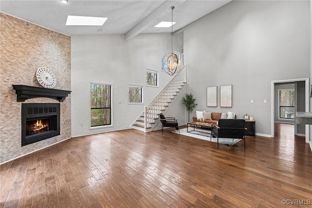 14323 Spring Gate Ct, Chesterfield, VA 23112 - living room featuring a high ceiling, a skylight, stairway, hardwood / wood-style flooring, and a fireplace