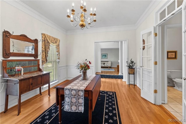 5158 Keitts Corner Rd, Mechanicsville, VA 23111 - dining room featuring a chandelier, light wood finished floors, crown molding, and wainscoting