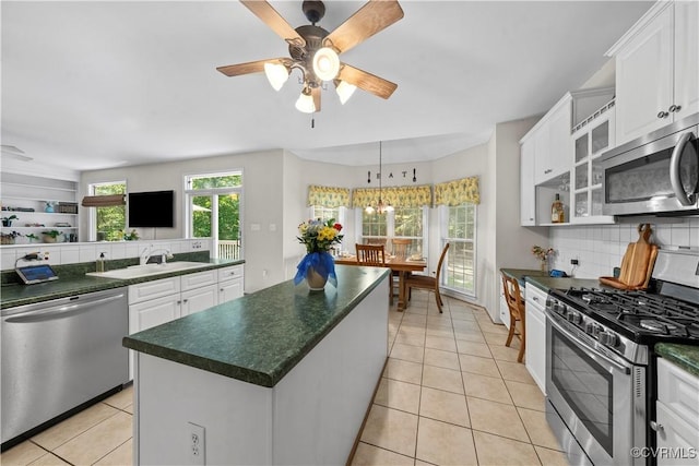5158 Keitts Corner Rd, Mechanicsville, VA 23111 - kitchen featuring appliances with stainless steel finishes, dark countertops, tasteful backsplash, a ceiling fan, and white cabinets