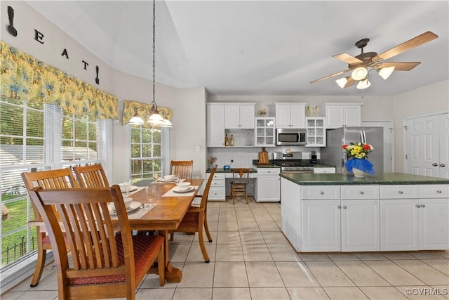 5158 Keitts Corner Rd, Mechanicsville, VA 23111 - kitchen with stainless steel appliances, dark countertops, decorative backsplash, light tile patterned floors, and white cabinets