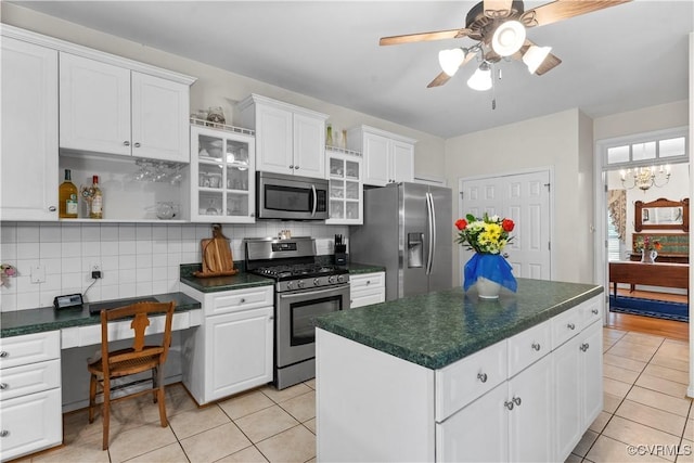 5158 Keitts Corner Rd, Mechanicsville, VA 23111 - kitchen featuring appliances with stainless steel finishes, light tile patterned flooring, dark countertops, and tasteful backsplash