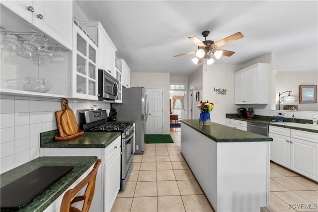 5158 Keitts Corner Rd, Mechanicsville, VA 23111 - kitchen featuring appliances with stainless steel finishes, a center island, tasteful backsplash, and dark countertops