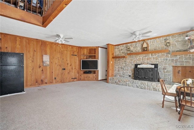 14401 Doctors Creek Rd, Lanexa, VA 23089 - carpeted living area with a ceiling fan, wooden walls, crown molding, a stone fireplace, and a textured ceiling