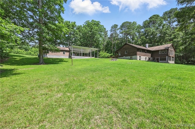 14401 Doctors Creek Rd, Lanexa, VA 23089 - view of grassy yard featuring a detached carport and view of wooded area