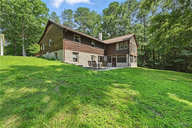 14401 Doctors Creek Rd, Lanexa, VA 23089 - back of house featuring stone siding, a chimney, a patio, and a lawn