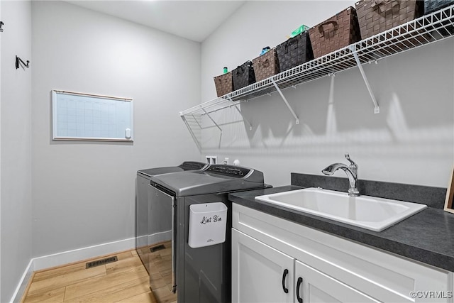 16319 Aklers Pl, Moseley, VA 23832 - laundry room featuring washing machine and dryer, light wood-style floors, baseboards, and cabinet space