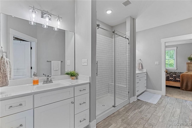 16319 Aklers Pl, Moseley, VA 23832 - bathroom featuring vanity, a stall shower, connected bathroom, wood finished floors, and baseboards