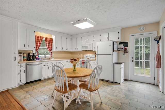 24390 Genito Rd, Amelia Courthouse, VA 23002 - kitchen with white appliances, white cabinetry, light countertops, a sink, and a textured ceiling