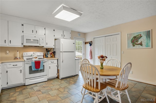 24390 Genito Rd, Amelia Courthouse, VA 23002 - kitchen featuring white appliances, light countertops, white cabinetry, a textured ceiling, and baseboards
