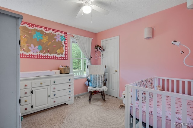24390 Genito Rd, Amelia Courthouse, VA 23002 - bedroom featuring a nursery area, light colored carpet, a textured ceiling, a ceiling fan, and baseboards
