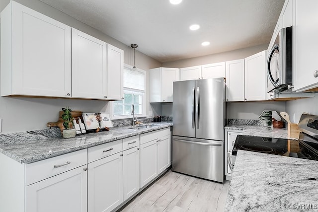 14560 Lodore Rd, Amelia Courthouse, VA 23002 - kitchen featuring appliances with stainless steel finishes, a sink, white cabinetry, light wood-type flooring, and recessed lighting