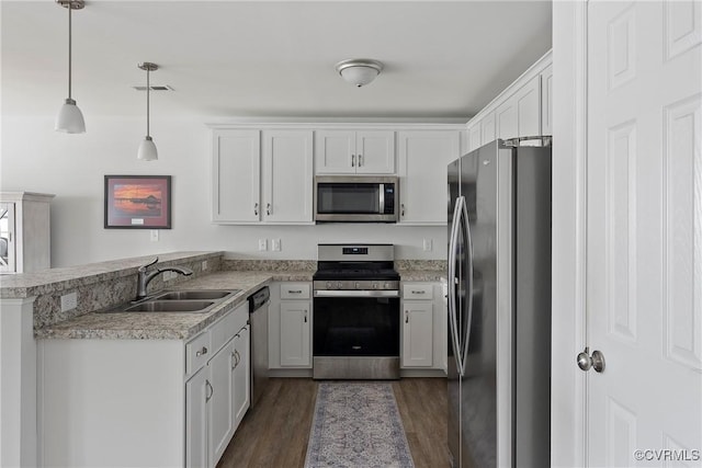 319 Wendenburg Ter, King William, VA 23009 - kitchen featuring appliances with stainless steel finishes, a sink, a peninsula, dark wood-type flooring, and white cabinetry