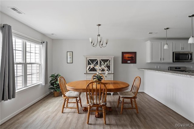 319 Wendenburg Ter, King William, VA 23009 - dining space with light wood finished floors, a chandelier, and baseboards