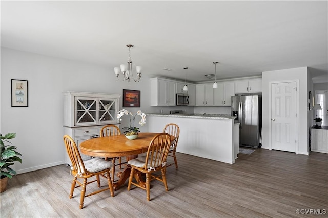 319 Wendenburg Ter, King William, VA 23009 - dining room featuring wood finished floors, a chandelier, and baseboards